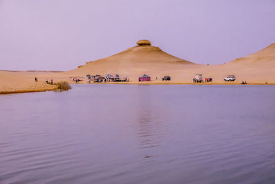 Scenic view of lake at desert against sky