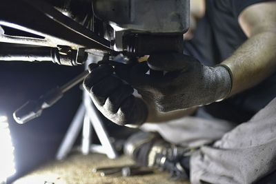 Midsection of man working in garage