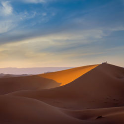 Scenic view of desert against sky during sunset