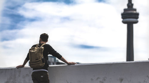 Low angle view of man standing against sky