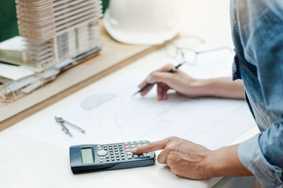 Midsection of woman working on table