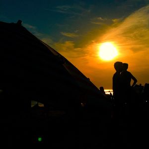 Silhouette of people at sunset