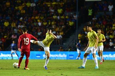 Group of people playing soccer on field