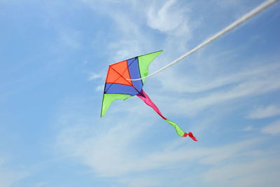 Low angle view of colorful kite flying against sky