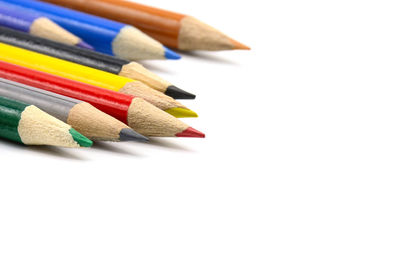 Close-up of colored pencils against white background