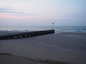 Scenic view of beach against sky during sunset