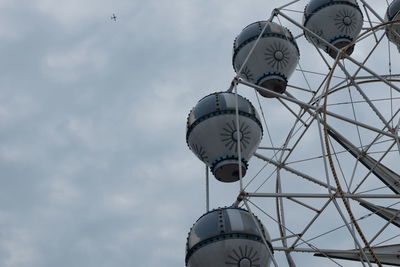 Low angle view of ferris wheel against sky