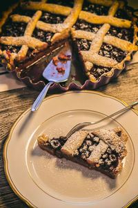 High angle view of cherry pie by sauce on table