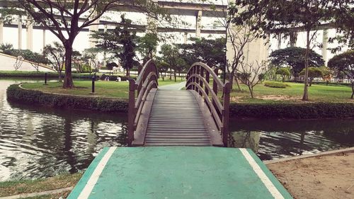 Walkway amidst trees against sky