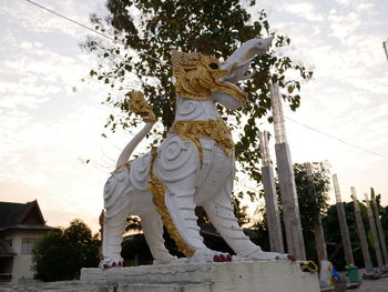 Low angle view of statue against sky