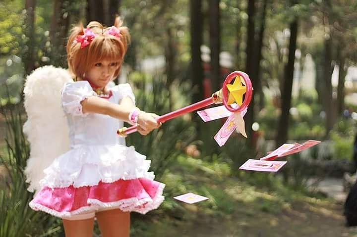 PORTRAIT OF CUTE GIRL PLAYING WITH UMBRELLA