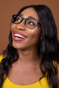 Smiling woman against brown background