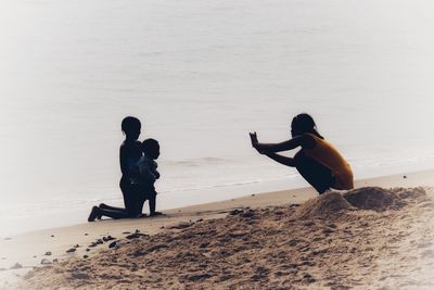 People on beach against sea