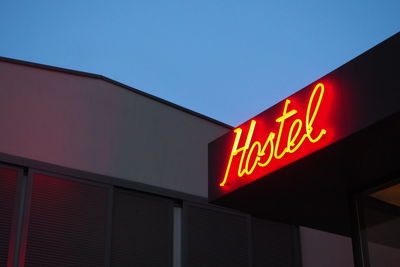 Close-up of illuminated text on building