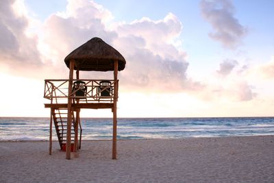 Lifeguard hut on beach against sky