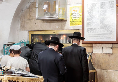 Rear view of jews praying in synagogue