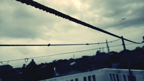 Silhouette of building against cloudy sky