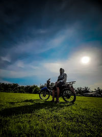 Bicycle parked on field against sky