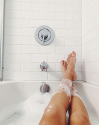 Low section of woman in bathroom at home