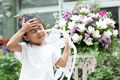 Full length of girl with pink flowers