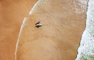 High angle view of people with surfboards at beach