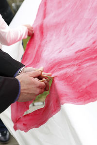 Midsection of bride with bouquet