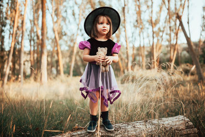 Portrait of a girl standing on field