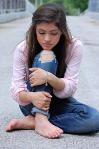 Portrait of cute girl sitting on wall