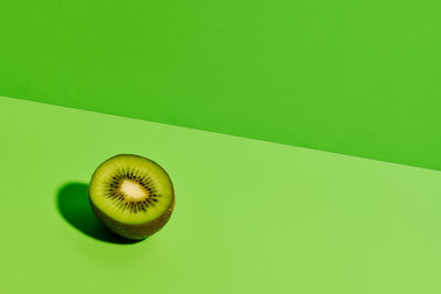 Close-up of lemon slice over green background