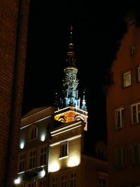 Low angle view of illuminated building against sky at night