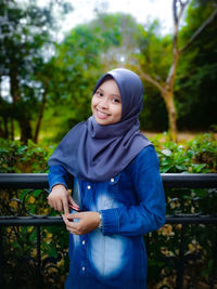 Portrait of smiling young woman wearing hijab