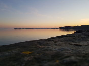 Scenic view of beach against sky during sunset