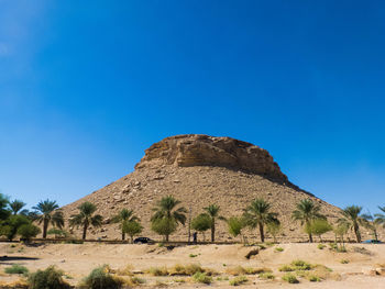 Built structure on desert against blue sky