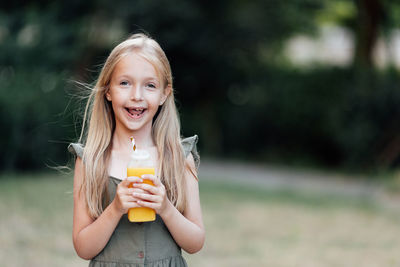 Portrait of young woman holding drink