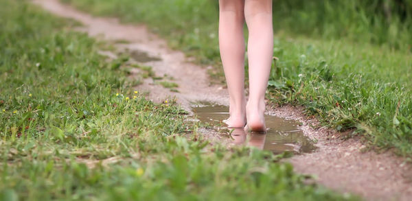 Low section of child standing on field