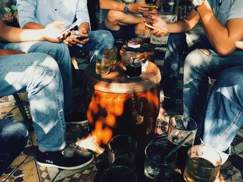 Low section of people sitting at table