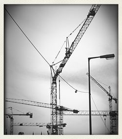 Low angle view of electricity pylon against sky