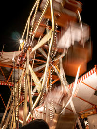 Low angle view of illuminated ferris wheel at night