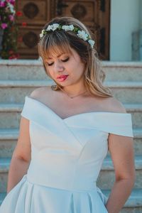 Young bride looking down outdoors