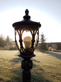 Close-up of street light on field against sky