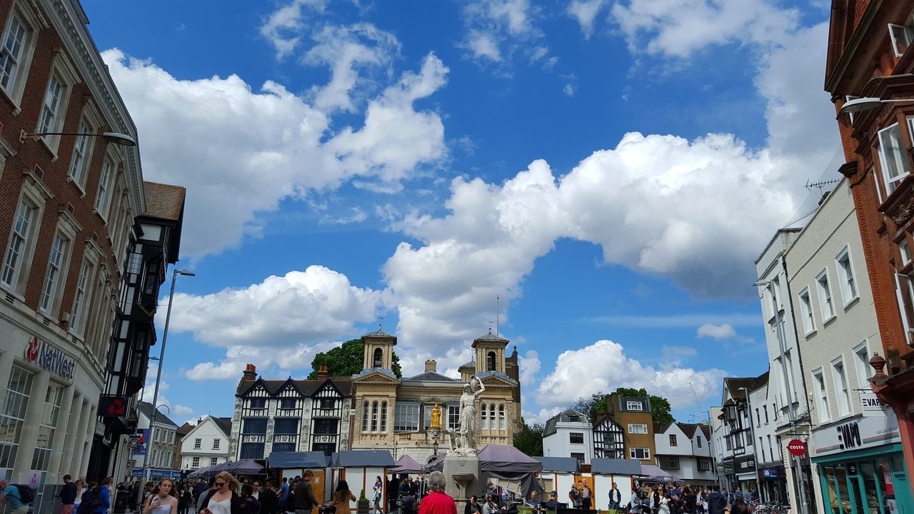 sky, building exterior, cloud - sky, architecture, built structure, day, outdoors, low angle view, large group of people, real people, city, people