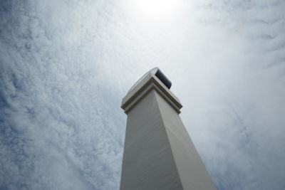 Low angle view of architectural column against cloudy sky