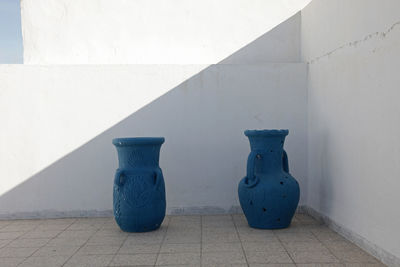 Old jugs against wall