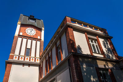 Low angle view of building against clear blue sky
