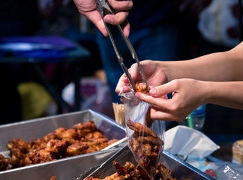 Midsection of person preparing food at market