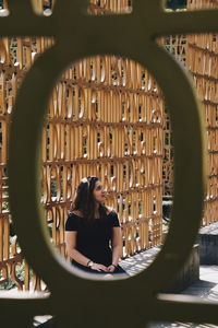 Woman seen through railing 