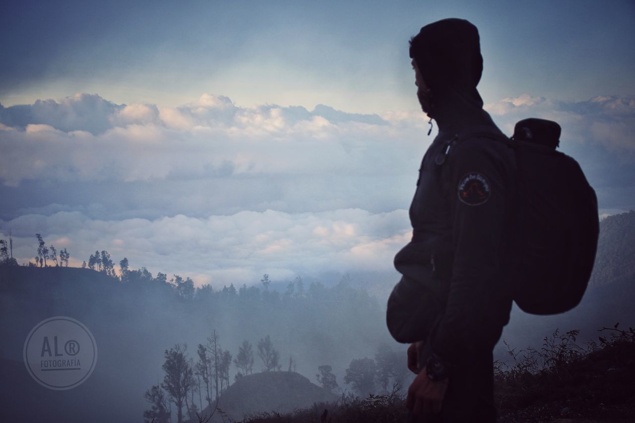 sky, cloud - sky, mountain, scenics - nature, one person, nature, beauty in nature, standing, tranquil scene, real people, leisure activity, tranquility, non-urban scene, lifestyles, mountain range, men, three quarter length, activity, sunset, looking at view, warm clothing
