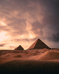 Scenic view of pyramids against sky during sunset