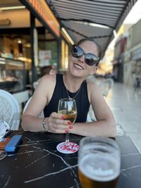 Portrait of young woman having drink at restaurant