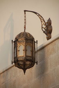 Low angle view of electric lamp on wall